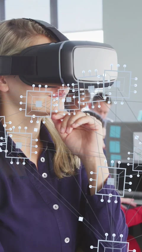 Vertical video: Developer lifting hand using VR headset and circuit UI to Stock Footage 333304929