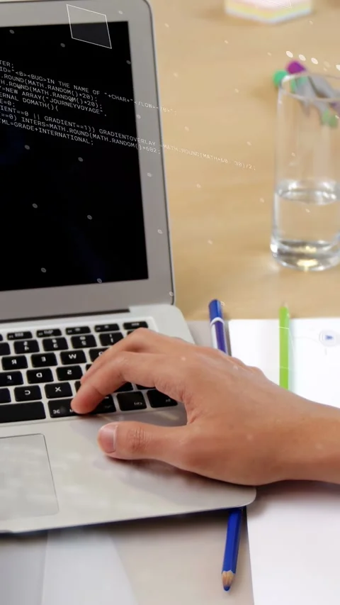 Vertical video: Developer lifting pen to plan change, typing on laptop while Stock Footage 334694947