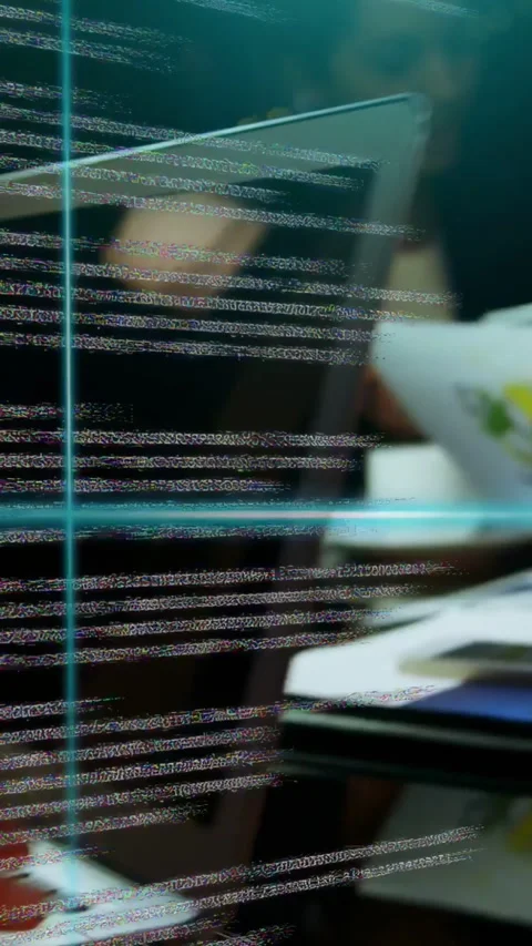 Vertical video: Developer reading tablet, causing dense tech code with teal Stock Footage 335802572