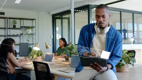 Vertical video: Developer tapping tablet in open office, generating UI panels 스톡 동영상 330305037