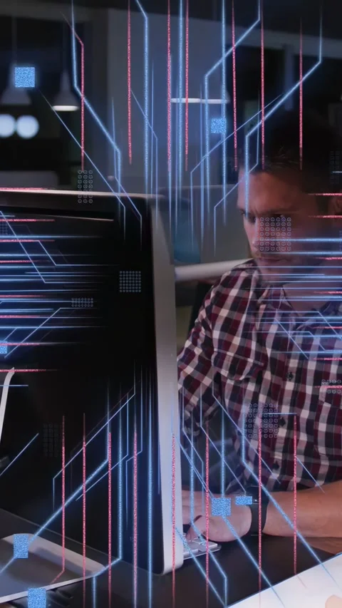 Vertical video: Developer watching screen while screen emitting neon code Stock Footage 333954125