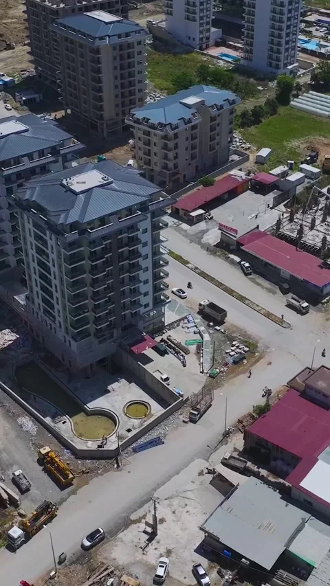 Vertical Video: Developing residential area with builders working on concrete Video stock 297674138