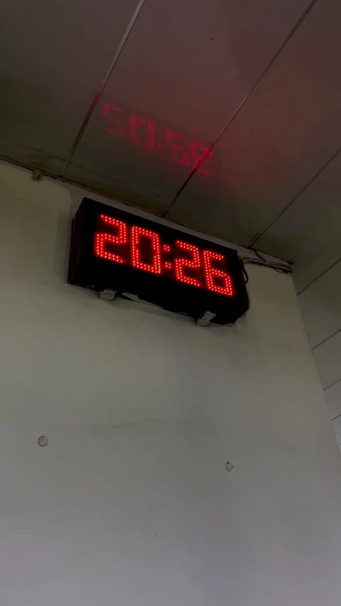 Vertical video. Digital clock with red lights changes time from 20:25 to 20:26 Stock Footage 322212947