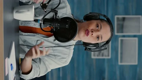 Vertical video: Digital content creator in studio at home recording daily vlog Stock Footage 199590788