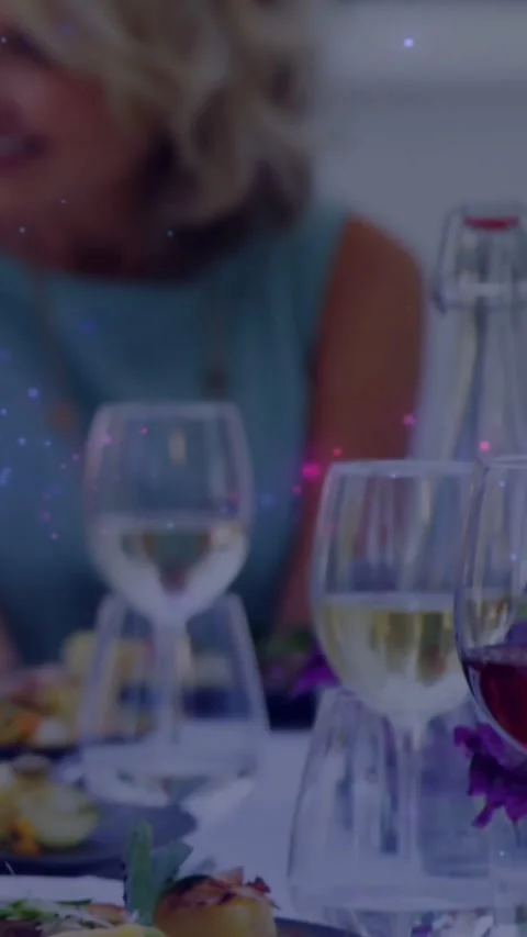 Vertical video: Diner dining and talking as camera pulling away from plate, glow Stock Footage 334544747