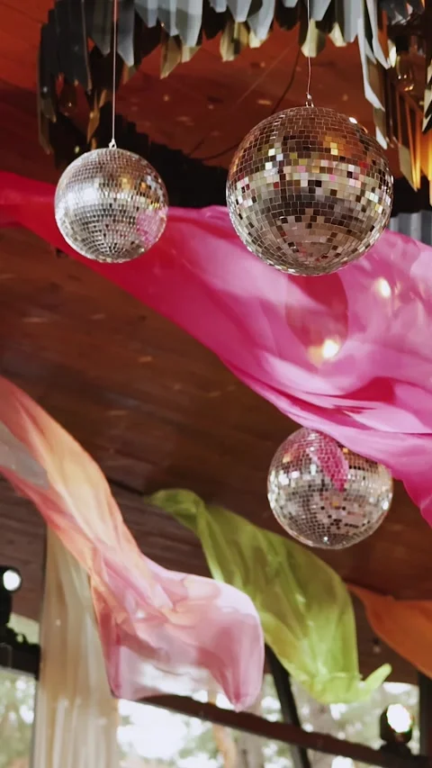 Vertical video. Disco balls. Party or wedding decor, festive lighting and fabric Stock Footage 324678487
