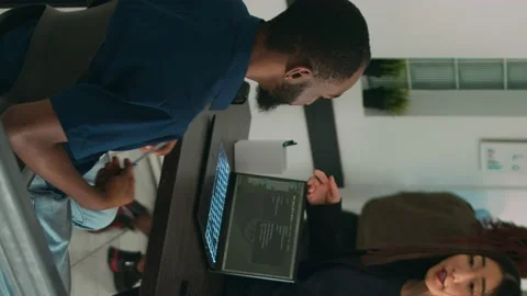 Vertical video: Diverse coders talking about source code on terminal window Stock Footage 219701699