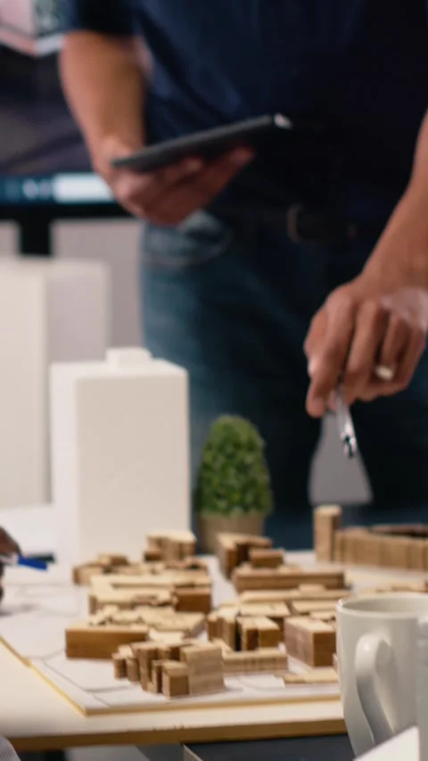 Vertical Video Diverse contractors real estate developers evaluating site Stock Footage 316185552