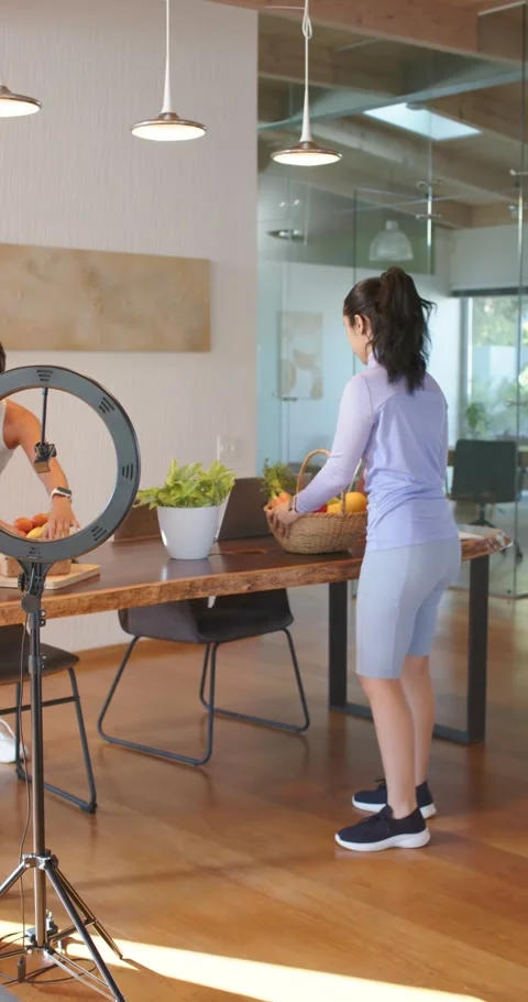 Vertical video: Diverse crew styling basket at kitchen table for shoot as man 스톡 동영상 335896769