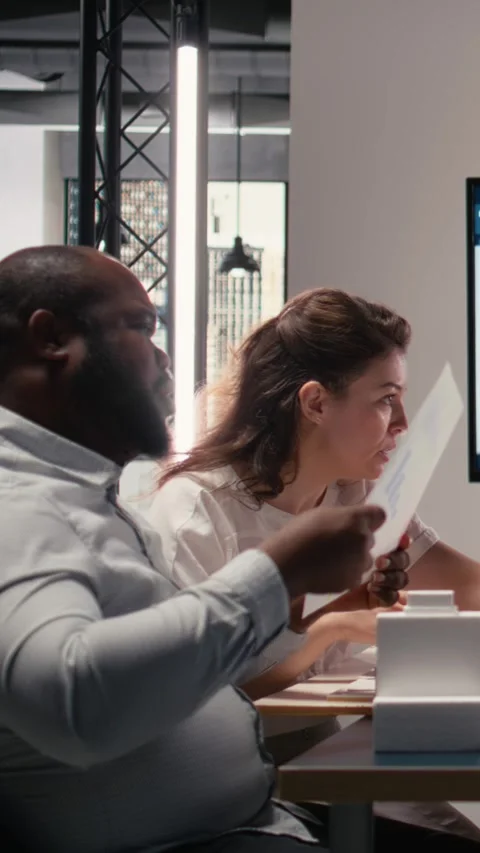 Vertical Video Diverse engineers team go over structural real estate city Stock Footage 316340192