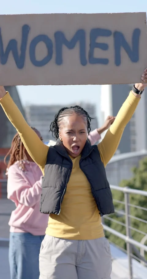 Vertical video: Diverse female protesters marching on roof after lifting WOMEN Stock Footage 338396176