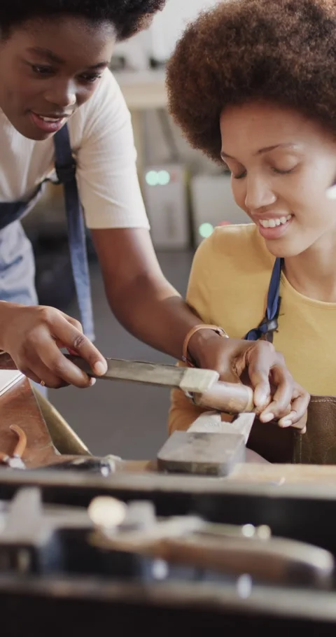Vertical video of diverse female workers shaping ring in workshop in slow motion Stock Footage 345490933