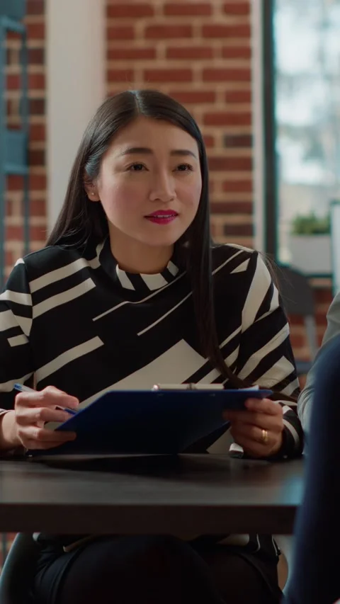 Vertical video: Diverse group of employees talking to applicant at job interview Stock Footage 201724757