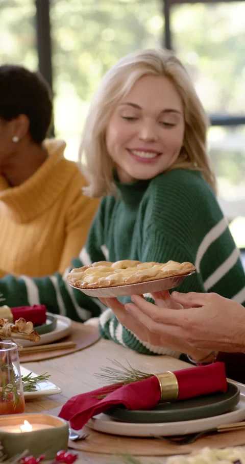 Vertical video: Diverse group passing pie leading blonde woman accepting toast Видео 346735290