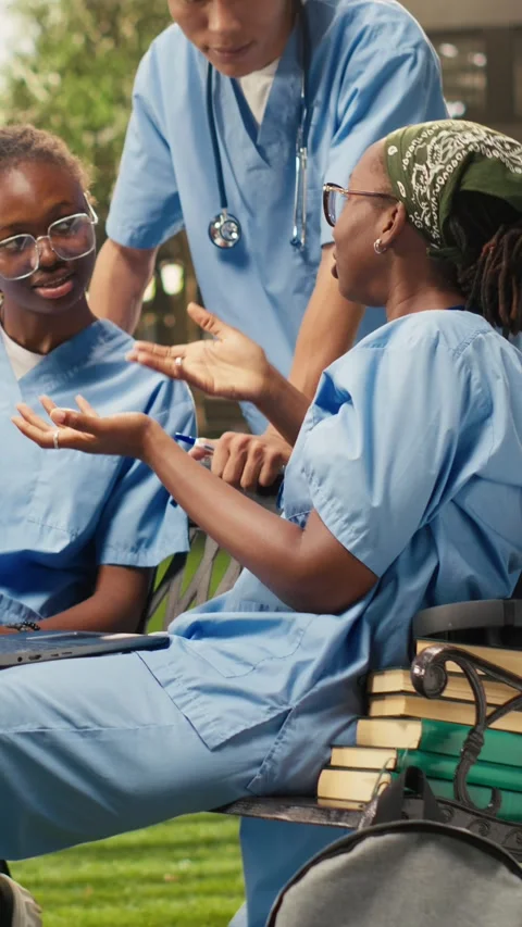 Vertical Video Diverse med school students learning together with coursework in Stock Footage 341321122