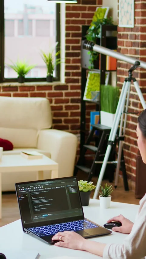 Vertical Video Diverse software developers team coding on a laptop in a cozy Stock Footage 319467322