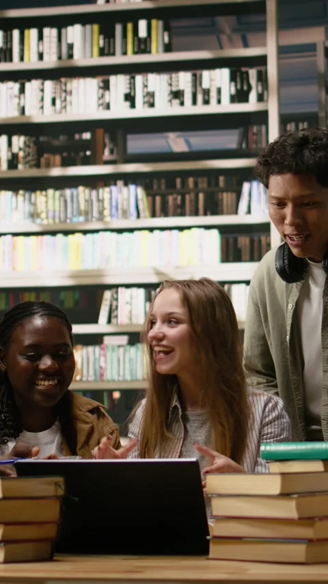 Vertical Video Diverse students working on laptop together at group study Stock Footage 337529584