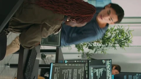 Vertical video: Diverse team of ai cloud programers talking about coding script Stock Footage 220160247