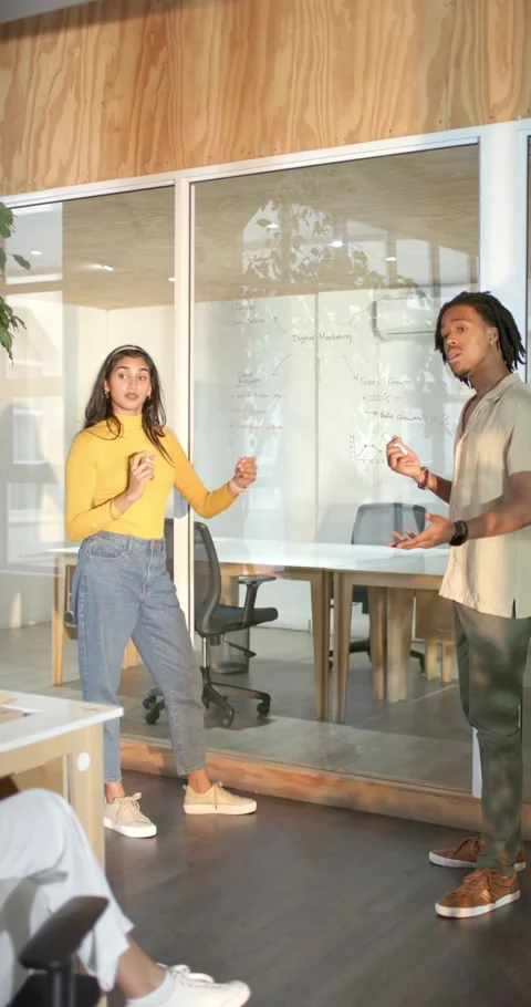 Vertical video: Diverse team collaborating by explaining and diagramming on Stock Footage 345491692