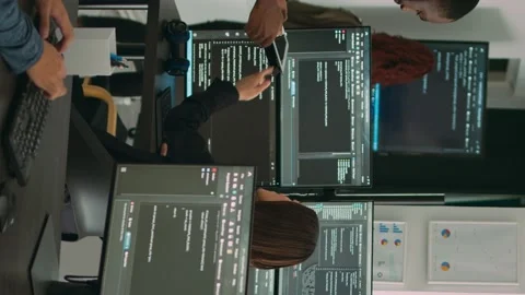 Vertical video: Diverse team of database developers analyzing code on terminal Stock Footage 219701746