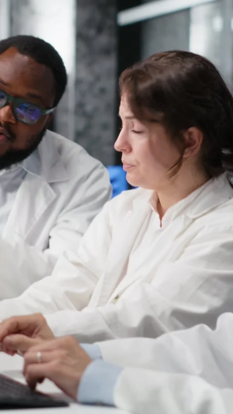 Vertical video Diverse team of research facility professional using PC software Stock Footage 319505867
