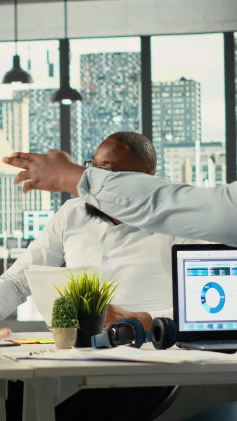 Vertical Video Diverse work team in multinational company analyzing metrics and Stock Footage 321780967