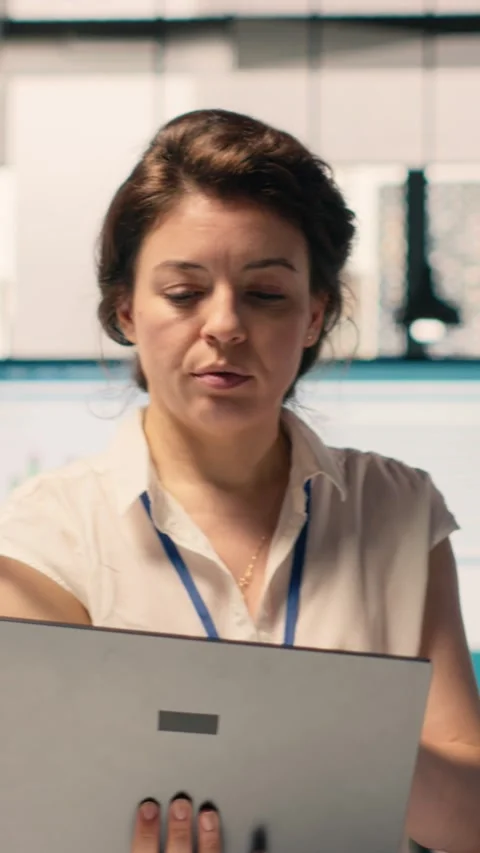 Vertical Video Diverse work team reviewing business intelligence reports and Stock Footage 329318657