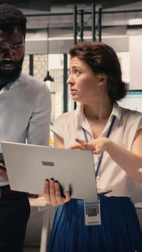 Vertical Video Diverse work team reviewing business intelligence reports and Stock Footage 329320687