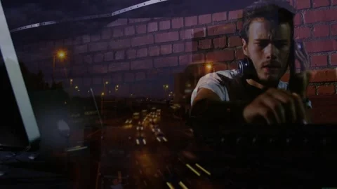 Vertical video: DJ checking laptop and cueing track, adjusting mixer while light Stock Footage 332746929