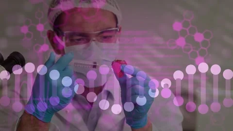 Vertical video: DNA overlay showing tech in PPE handling red sample with pipet Stock Footage 330463260