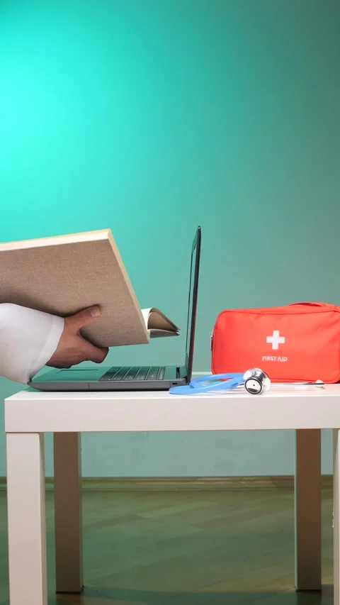 Vertical video doctor hand holding a medical textbook while working on a Stock Footage 347239341