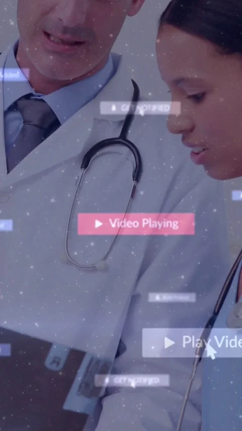 Vertical video: Doctor pointing tablet trainee leaning showing floating play UI Stock Footage 331238658