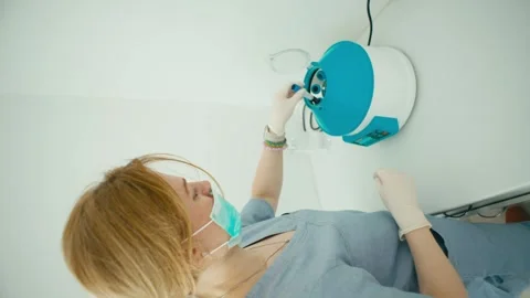 In the vertical video, the doctor puts test tubes in a centrifuge. Stock Footage 276873869