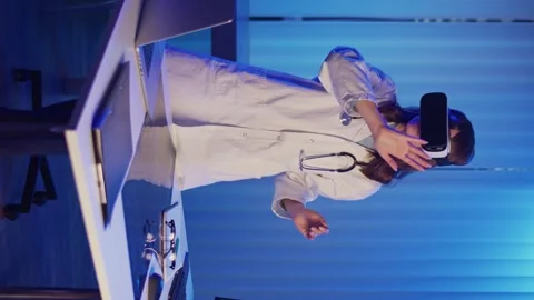 Vertical Video. Doctor Using Augmented Reality for Medical Research Stock Footage 318229369