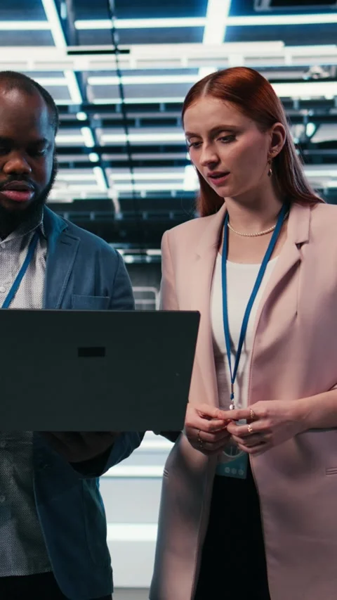 Vertical video Doing maintenance, laptop and engineering team in server hub Stock Footage 330085224