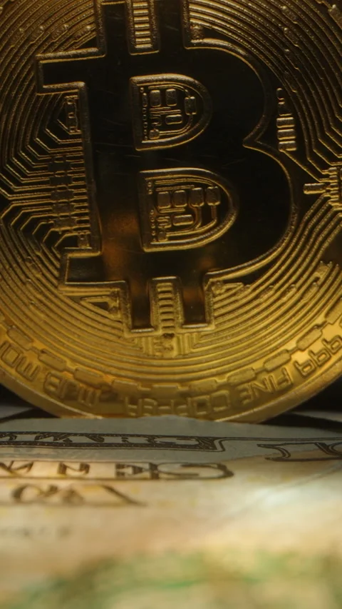 Vertical video. Dolly slider, close up. Close-Up of Golden Bitcoin Coin Standing Stock Footage 296556829