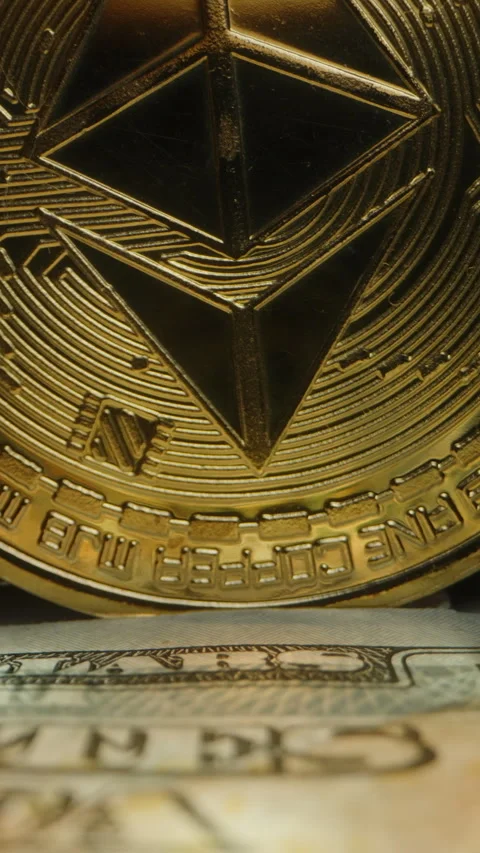 Vertical video. Dolly slider, close up. Golden Ethereum Coin Standing Upright on Stock Footage 296562273