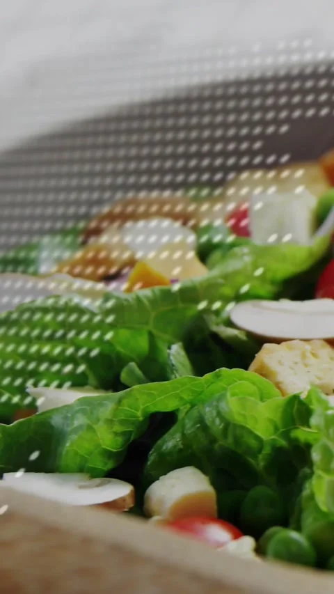 Vertical video: Dotted overlay appearing while camera shifting, revealing salad Stock Footage 334395965