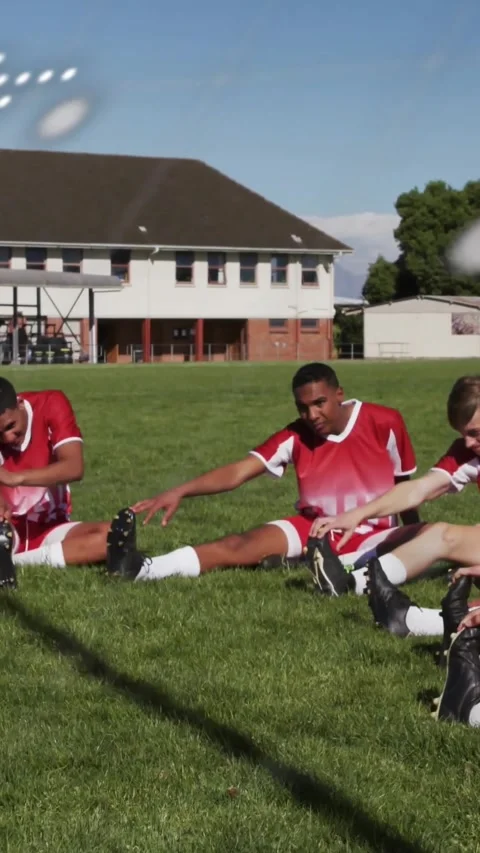 Vertical video: Dotted overlay sweeping frame revealing teen players stretching Stock Footage 334382213