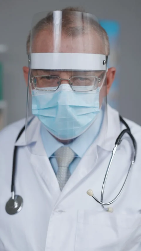 Vertical Video of Dramatic Shot of Heroic and Overworked Medical Worker Wearing Stock Footage 304991154