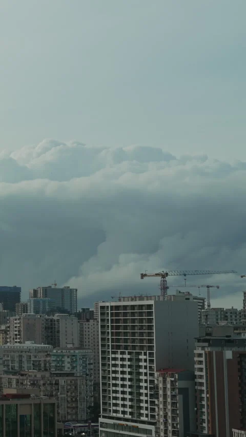 Vertical video dramatic storm clouds is approaching the city. Thunderstorm Stock Footage 335852915