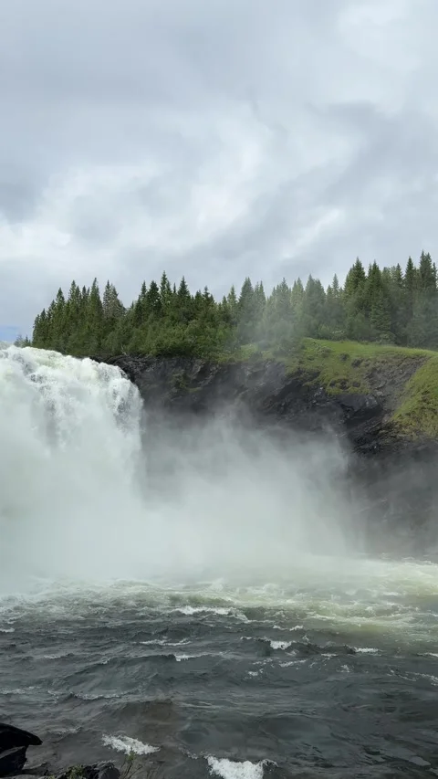 Vertical video of dramatic waterfall splashing into misty rocky canyon Stock Footage 315358549