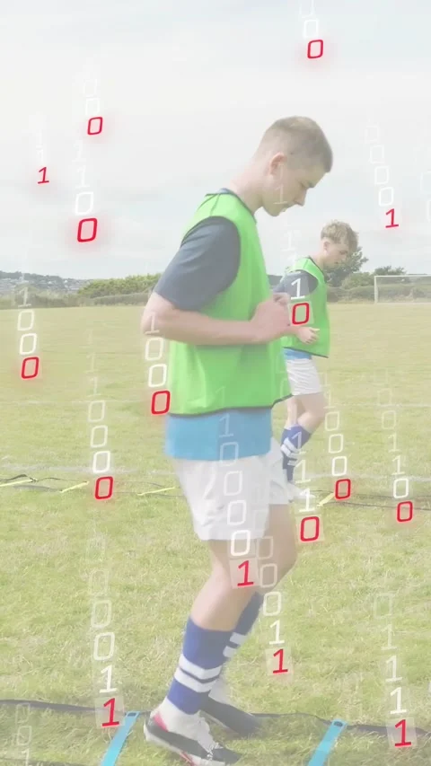 Vertical video: Drill starting, green-bib male doing soccer ladder, binary Stock Footage 333496304