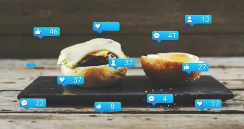 Vertical video: Dripping sauce from top, two buns on slate attracting blue icons Stock Footage 331503247