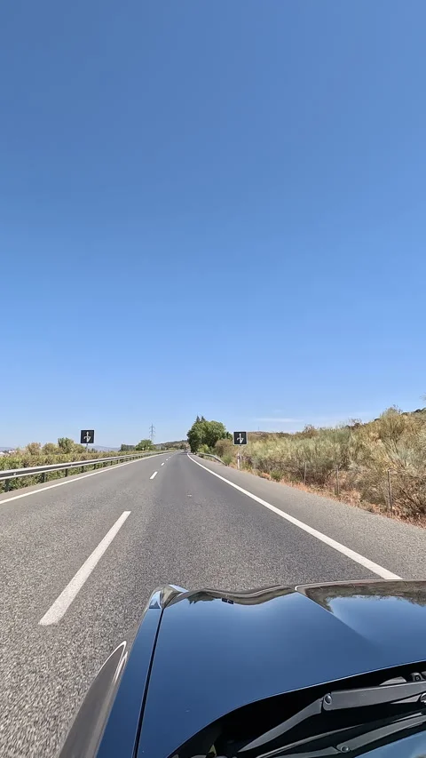 Vertical video driving on highway under clear blue sky Stock Footage 332065215