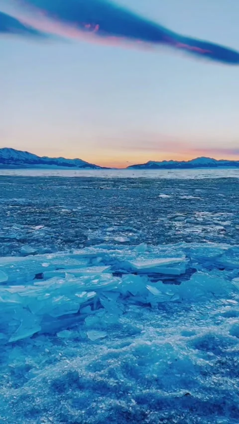 Vertical Video of Drone Flying Over Frozen Blue Ice Lake at Sunset, China Video stock 328389237
