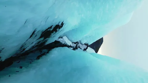 Vertical video: Drone shot of ice mass on frozen water Stock Footage 241370049