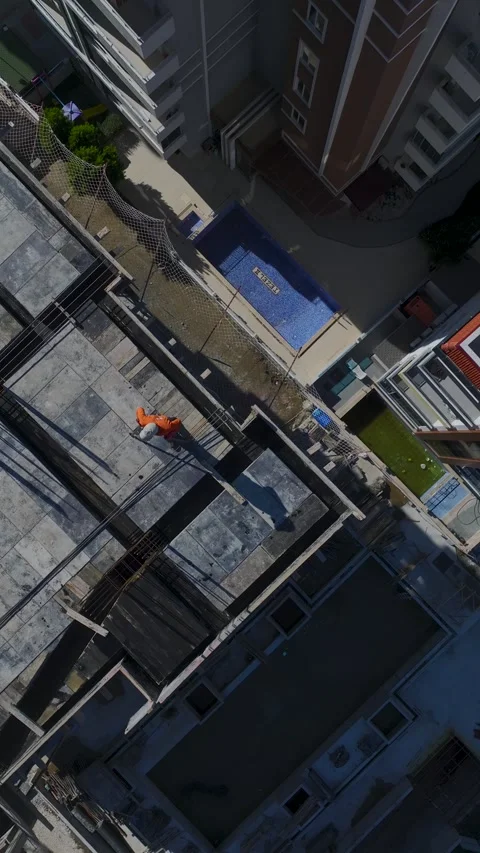 Vertical Video Drone Shot of Worker Installing Rebar on Rooftop Construction Stock Footage 342471084