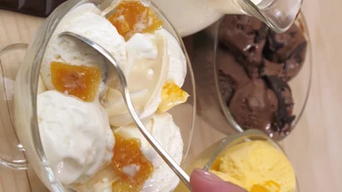 Vertical video. Drop your hand with a teaspoon to take the vanilla ice cream. Video stock 220104766