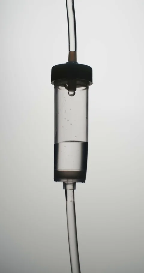 Vertical video: Dropper. Liquid or saline slowly dripping in center of frame 스톡 동영상 126158920